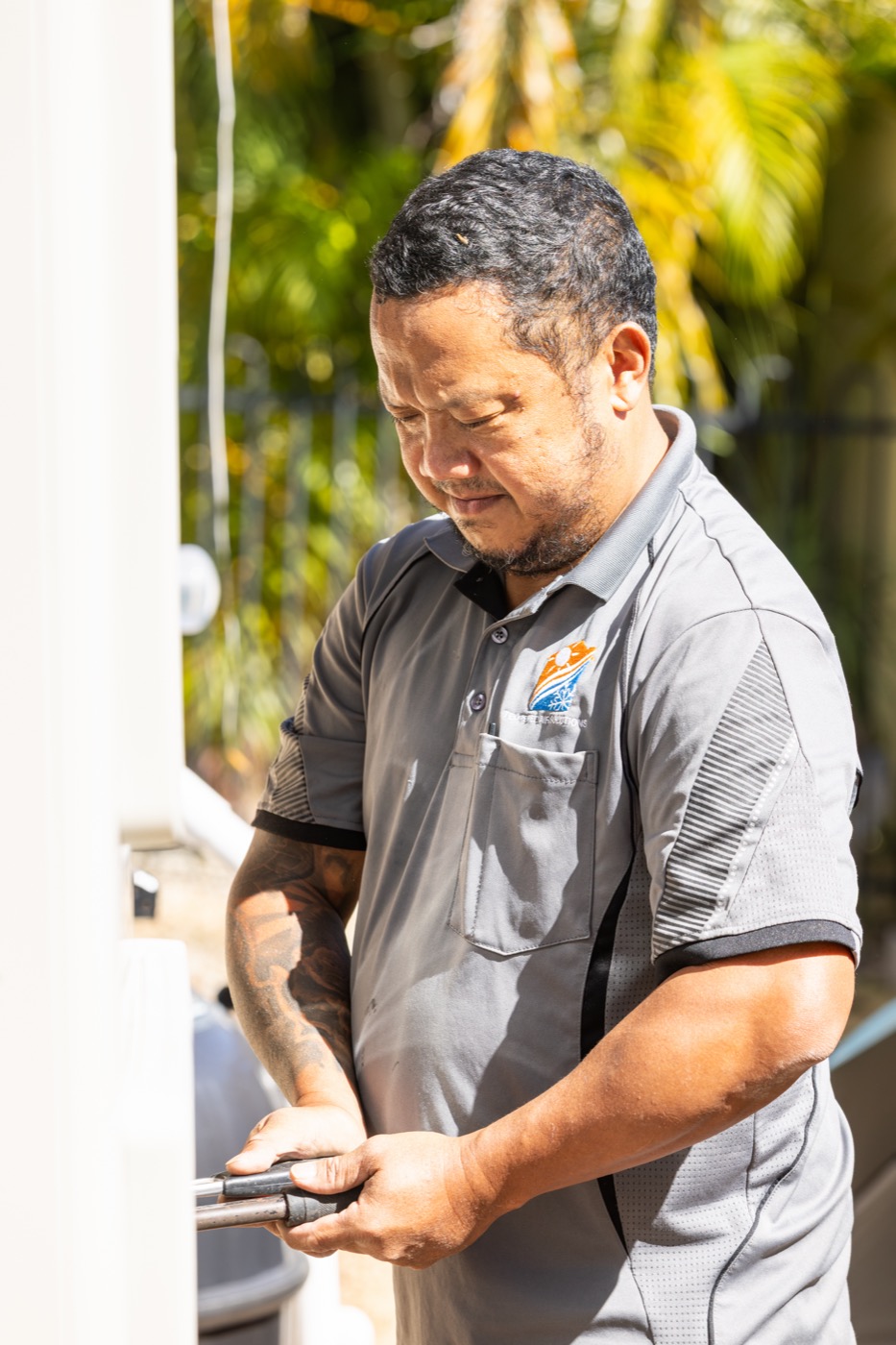 Technician working on an outdoor unit