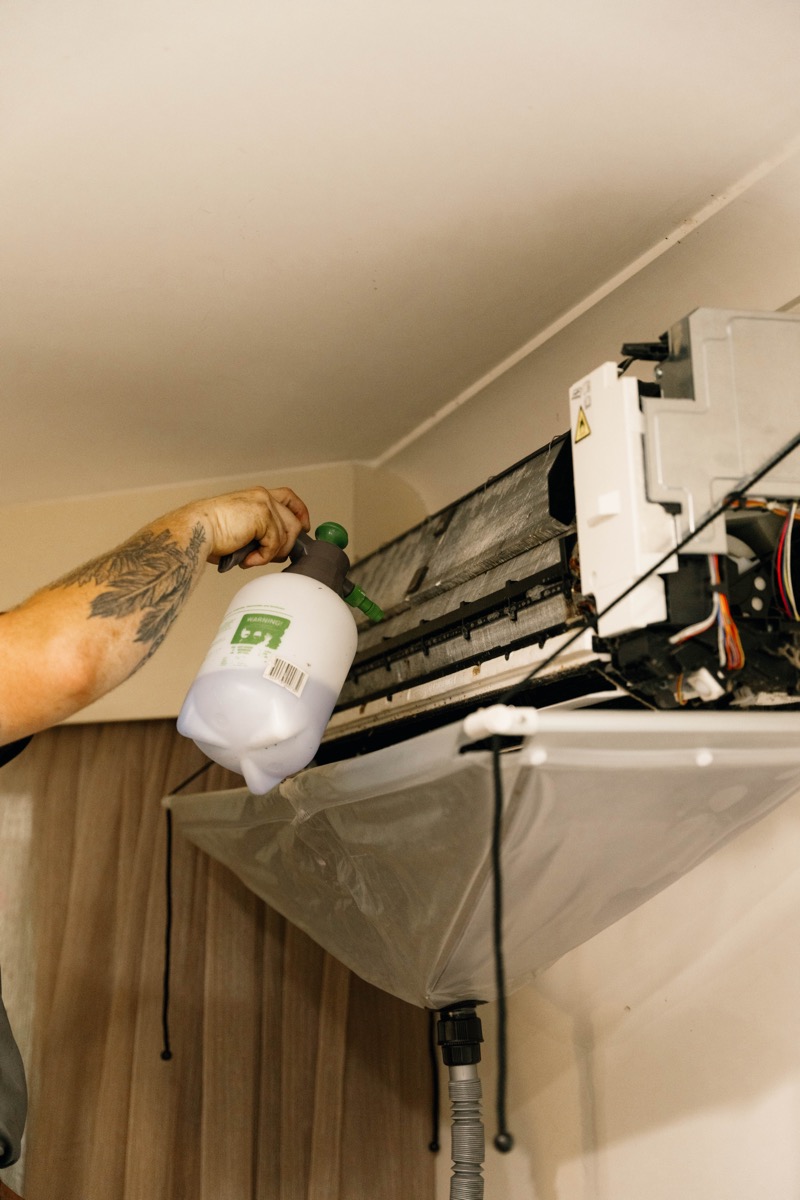 Technician servicing a split system